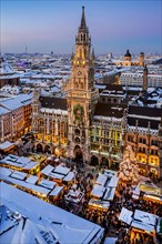 Snow-covered Marienplatz with Christmas market, Christmas market and town hall at dusk, Munich,