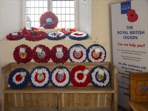 Village parish church Shotley, Suffolk, England, UK Royal British Legion remembrance poppy wreaths