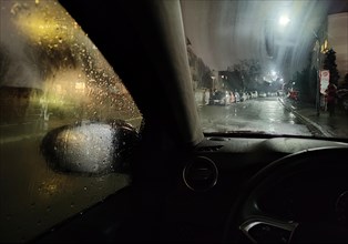 View from the car in dangerously poor visibility at night with rain and steamed-up windows,