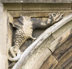Mythological folklore figure of a griffin dragon carved in stone on the entrance doorway to the
