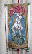 Interior of the priory church at Edington, Wiltshire, England, UK, banner of Saint George killing