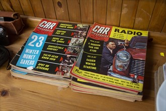 Two piles of Car Mechanics magazines on display at auction, UK