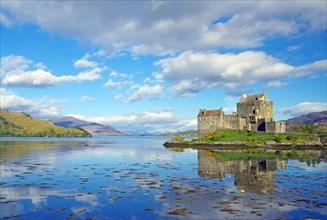 Eilean Donan Castle reflected in the water on a calm evening, filming location for James Bond,