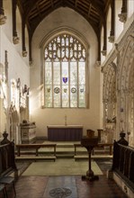 Interior historic village parish church, Wingfield, Suffolk, England, UK altar and east window