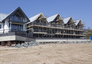 New beachfront modern housing development, Admiralty Pier, Shotley, Suffolk, England, UK under