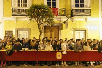 Spectators, crowd, passers-by, Semana Santa, procession, night shot, festivities in Tarifa, Spain,