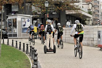 Tourists on a cruise ship during a shore excursion with bicycles and Segway, Praca Marques de