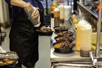 Detroit, Michigan, Workers prepare food at Yum Village restaurant, which serves Afro-Caribbean