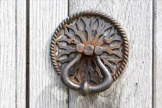 Old iron door handle on church door at Aldham, Suffolk, England, UK