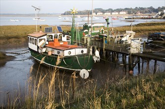 Houseboats on River Deben tidal estuary at Felixstowe Ferry, Suffolk, England, UK