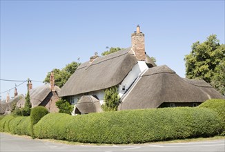Attractive thatched village houses at Wilcot, Pewsey Vale, Wiltshire, England, UK