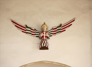 Carved and painted wooden angel on wall, Holy Trinity church, Blythburgh, Suffolk, England, UK