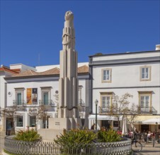 People sitting in sunshine outside street cafes in Praca da Republica, Tavira, Algarve, Portugal,