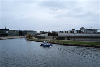 A police boat travels up the River Spree close to the German Bundestag building on a day of