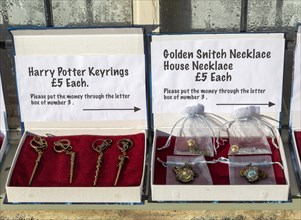 Display boxes Harry Potter souvenir products on sale on trust outside house, Lacock, Wiltshire,