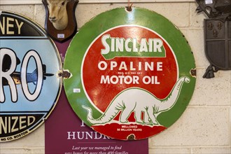 Vintage Sinclair Oplaine motor oil metal advertising sign on display at auction