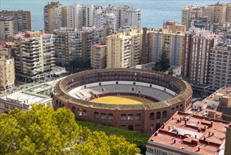 Historic bullring in city of Malaga surrounded by high rise apartments, Malaga, Andalusia, Spain,