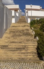 Diminishing converging lines, perspective flight of concrete steps outdoors climbing between two