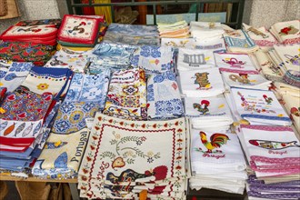Display of tea towel textile souvenir products of butterflies and fish on sale, city of Evora, Alto