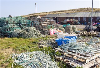 Fishing ropes, lobster pots and equipment on quayside Holy Island, Lindisfarne, Northumberland,