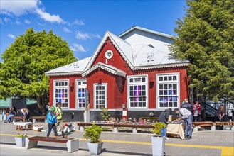 Historic red wooden house and street vendors with their displays, Ushuaia, Tierra del Fuego Island,