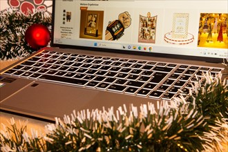 Symbolic image of Christmas shopping on the internet/at Amazon: Christmas decorations and laptop