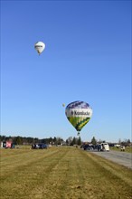Three hot air balloons take off from the airfield, Montgolfiade Tegernseer Tal, Balloon Week