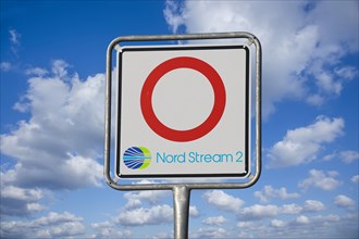 Symbolic image Nord Stream 2: Traffic sign with logo in front of blue sky (Composing)