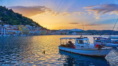 Harbour view at sunset with boats and glowing water reflections, Gythio, Mani, Peloponnese, Greece,