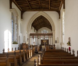 Village parish church Parham, Suffolk, England, UK view of chancel arch rood screen and east window