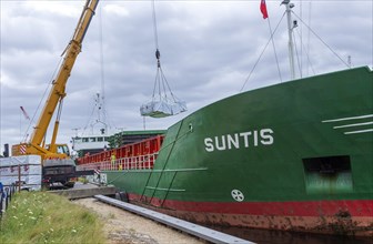 Crane unloading cargo ship Suntis at Anglo-Norden timber merchants, Wet Dock, Ipswich, Suffolk,