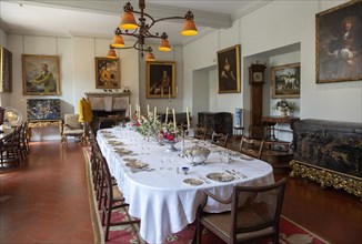 Dining room inside Berkeley castle, Gloucestershire, England, UK with table laid for dinner