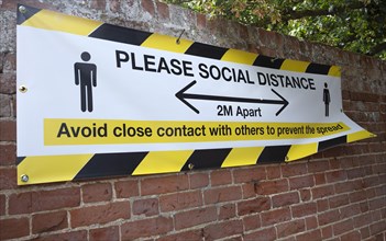 Please Social Distance 2 metres apart banner Avoid close contact with others to prevent the spread,