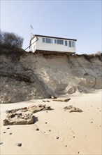 March 2018, Clifftop property collapsing due to coastal erosion after recent storm force winds,