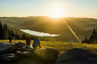 Hiking group, view from Hochfirst to Titisee and Feldberg, sunset, near Neustadt, Black Forest,