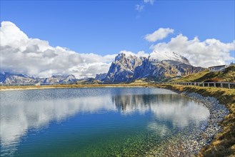 Reservoir with view of the Sassolungo and Sassopiatto, reflection, clouds, Dolomites, Alpe di