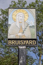 Saint Clare by Anne Smith on Bruisyard village sign, Suffolk, England, UK