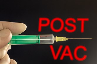 Symbolic image of vaccination damage caused by the corona vaccination: close-up of an injection