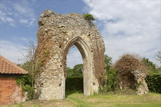 Ruined stone arch of abbey church, Butley priory, Suffolk, England, UK