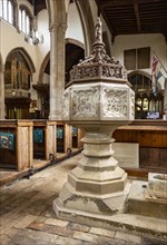 Historic interior of East Bergholt church, Suffolk, England, UK baptismal font