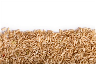 Texture of brown rice isolated on white background. Top view. Copy space