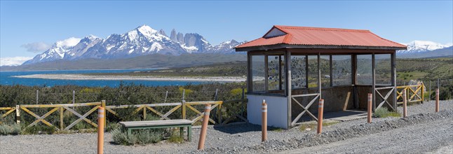 Mountain range with lake, in the foreground hut with wildlife protection fence, Torres del Paine