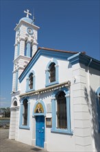 A white church with blue sky and decorative tower, Monastery of St Nicholas, Monastery of Agios