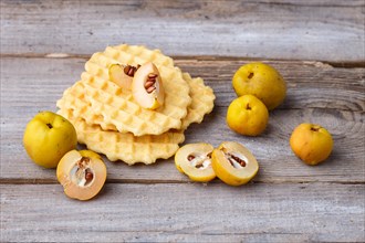 Sweet waffle and quince on a rustic wooden background