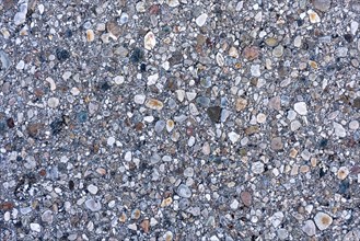 Asphalt road surface, enclosed colourful stones, grainy, pattern, structure, background, wallpaper