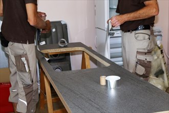 Craftsmen installing a new kitchen (kitchen assembly)