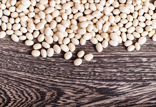 Texture of white beans isolated on a gray wooden background. Closeup