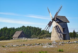 Old windmill with partially destroyed sails under a blue sky, Oeland, Sweden, Europe
