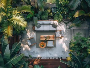 A serene courtyard with tropical plants, stone tiles, and comfortable outdoor furniture bathed in