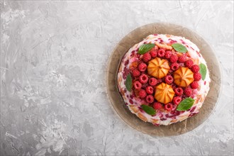 Homemade jelly cake with milk, cookies and raspberry on a gray concrete background. top view. flat